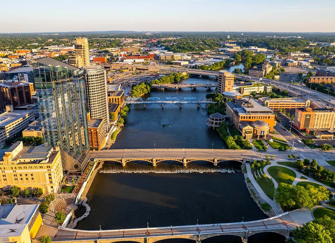 Grand Rapids, MI - Aerial View of Downtown Grand Rapids Michigan at Sunset with Views of Commercial Buildings and Bridges Across the River
